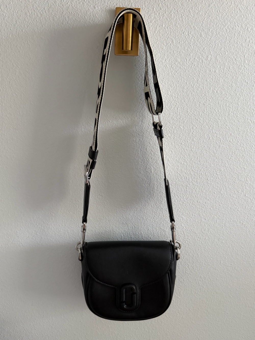 Marc Jacob’s Black Crossbody Saddle Bag with Patterned Strap